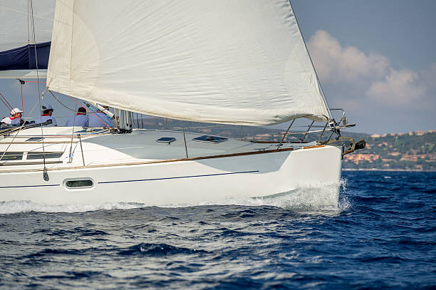 istock White sailing boat at charter cruise with a crew sitiing 611887084