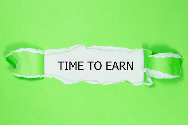 istock TIME TO EARN message written under torn paper. 611887522