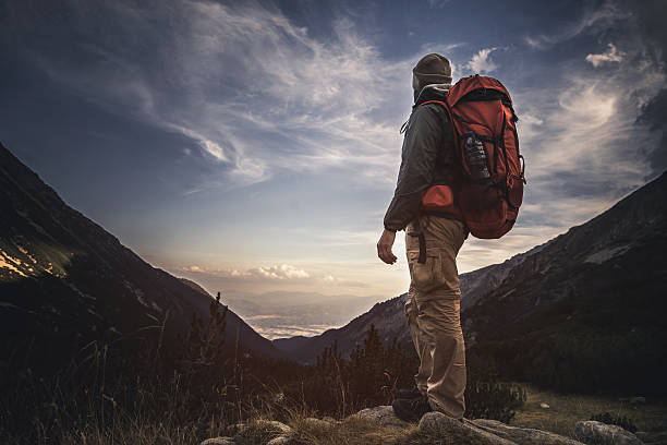 istock Traveler watching the sunset over the mountains 611887796