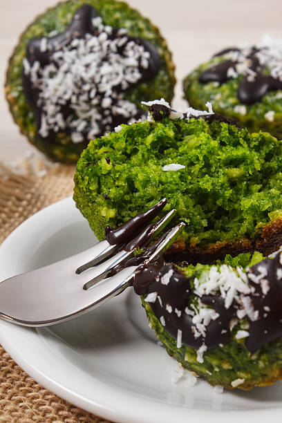 istock Fresh muffins with spinach, desiccated coconut and chocolate glaze 611887980