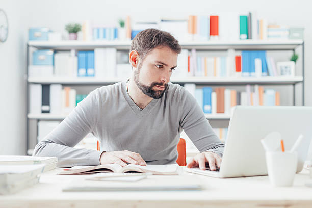 istock Man studying and connecting with a laptop 611888392