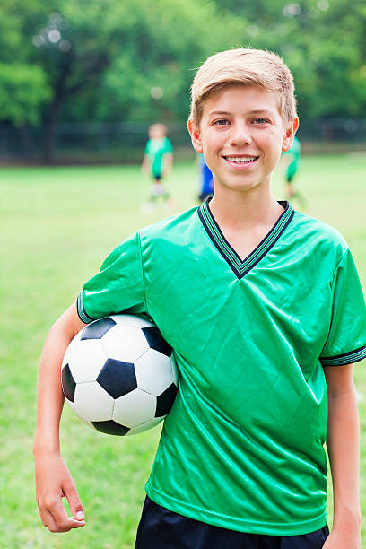 istock Handsome soccer athlete with ball 611888454