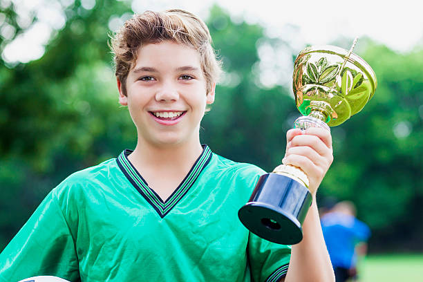istock Confident Caucasian soccer player with trophy 611888532