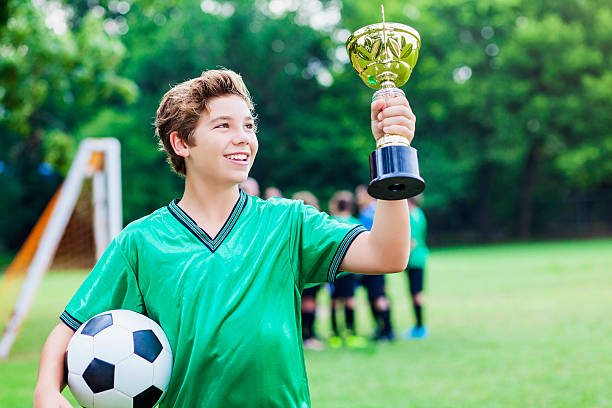 istock Soccer player admires trophy 611888576