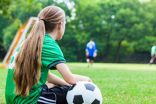 istock Lonely teenage soccer player sits on the sidelines 611888942