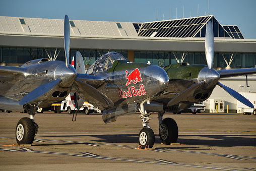 Jersey, U.K. - September 8, 2016: The P38 Lightning WW2 vintage aircraft, stationary at Jersey airport before the 2016 Airshow. Sponsored by Red Bull which keeps her in the air and maintained for generations to come.