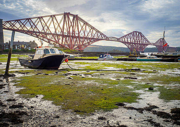 istock Boat moored in front of the Forth Rail Bridge 611889432
