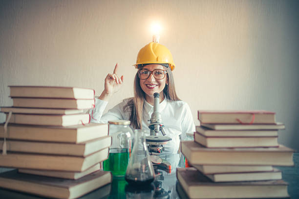 Brilliant idea Young student scientist sitting at a desk and having an idea brain jar stock pictures, royalty-free photos & images