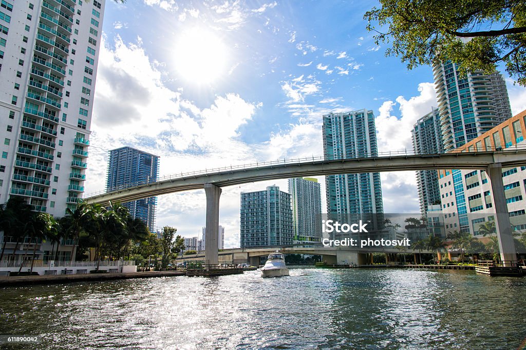 Downtown Miami  with Brickell Key in the background Downtown Miami along the Miami River inlet with Brickell Key in the background and yacht cruising ander the bridge Miami Stock Photo