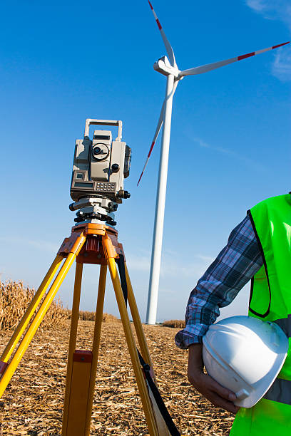 istock female surveyor engineer at windfarm 611890294