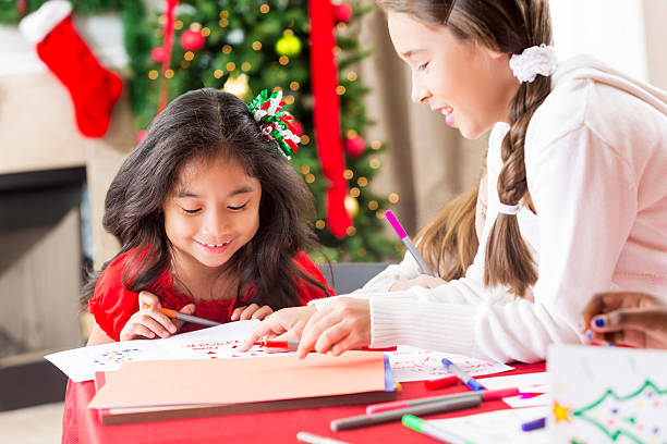 istock Two young girls creating Christmas cards 611890468