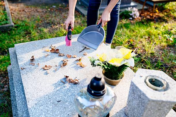 istock Woman cleans the grave. 611891376