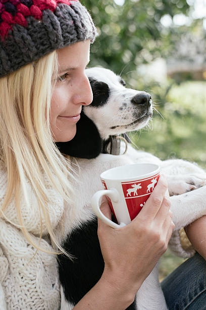 istock Woman and her puppy drinking together 611891440