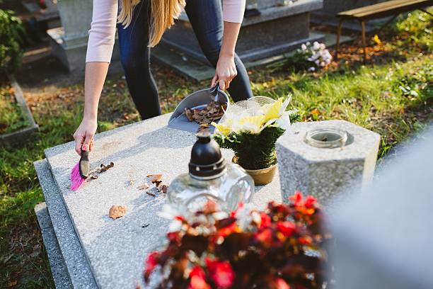 istock Woman cleans the grave. 611891584