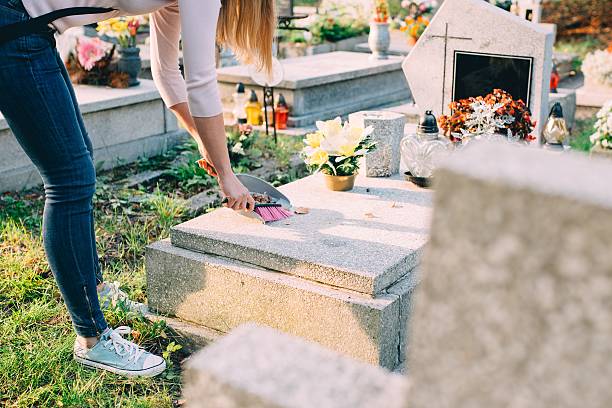 istock Woman cleans the grave. 611891720