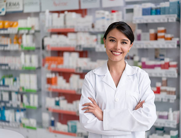 Pharmacist working at the drugstore Portrait of a pharmacist working at the drugstore and looking at the camera smiling pharmacist stock pictures, royalty-free photos & images