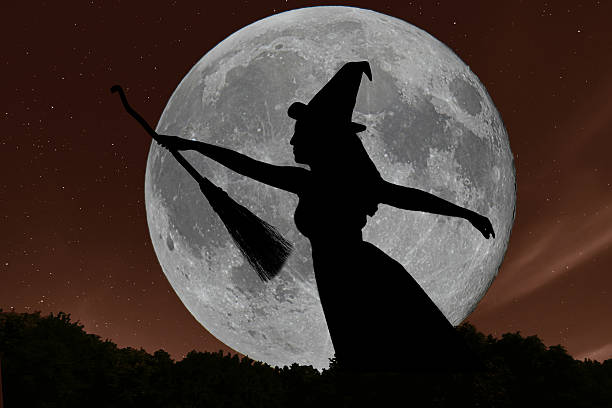 istock Halloween witch silhouette flying with broomstick. Full Moon. 611894692