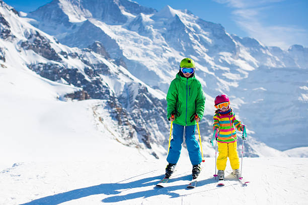 istock Children skiing in the mountains 611894966