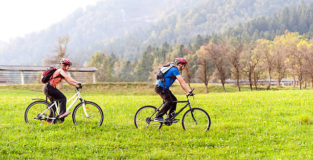 bikers riding on a mountain trail - sport exercising men julian alps imagens e fotografias de stock