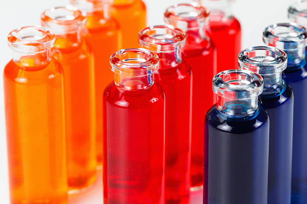 Liquid in chemical lab test tubes. Closeup background on white