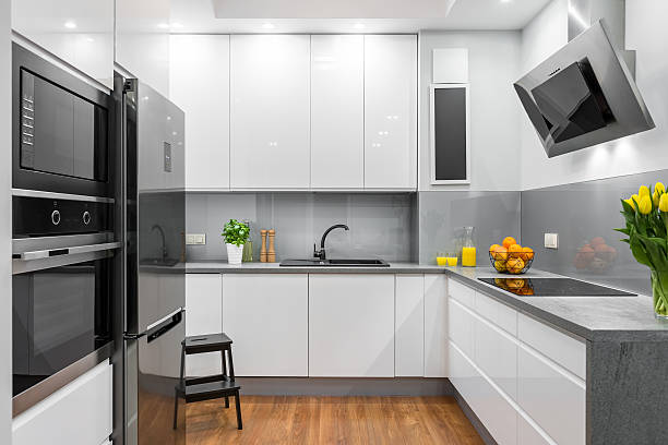 White kitchen in modern style idea New design open kitchen with white furniture and floor panels electromagnetic induction stock pictures, royalty-free photos & images