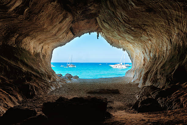 istock View from inside big cave to the beach 611896118