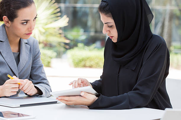 istock Business people meet outdoors in Dubai. 611896960