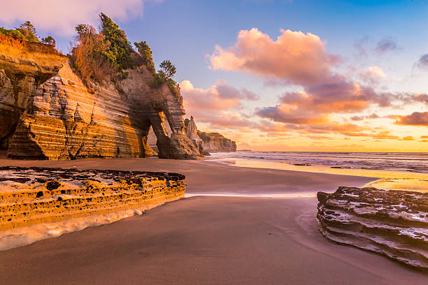 Sunset at a rocky beach Tongaporutu beach in Taranaki region, the North Island of New Zealand, is famous for its bizarre rock formations north island new zealand stock pictures, royalty-free photos & images