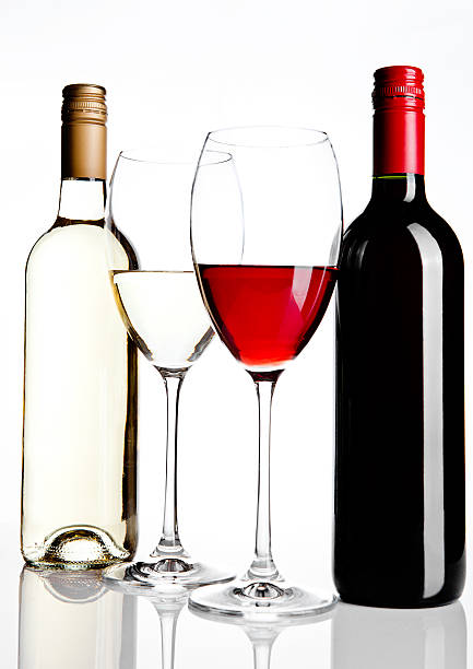 istock Bottles and glass of red and white wine reflection 611897736