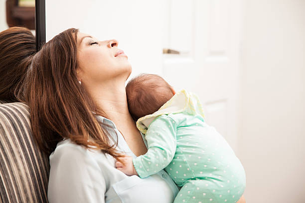 istock Mom falling asleep with her baby 611897944