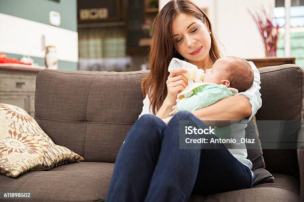 Woman Feeding Formula To Her Baby Stock Photo - Download Image Now - Baby - Human Age, Infant Formula, Baby Bottle