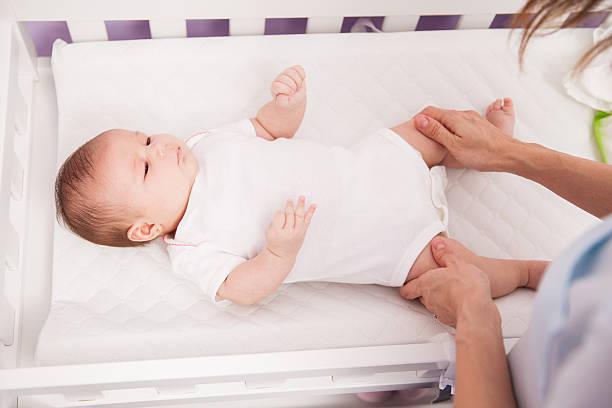 istock Cute newborn baby in a changing table 611899080