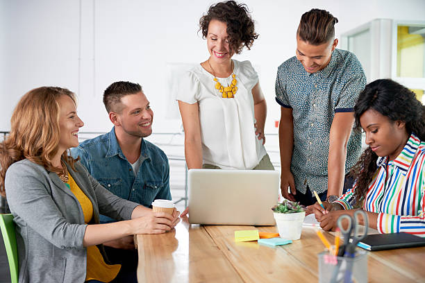 istock Multi ethnic group of succesful creative business people using a 611899574