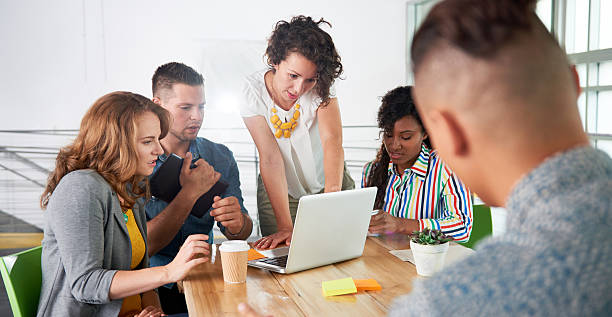 istock Multi ethnic group of succesful creative business people using a 611899640