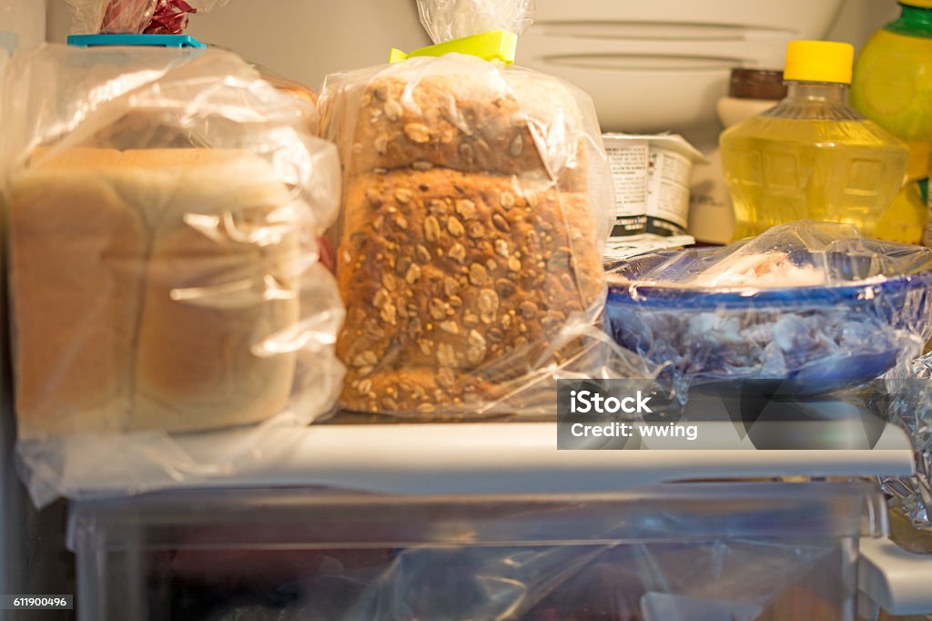 Inside a Home Fridge with bread  and other articles Inside a Home Fridge with bread and other articles-  with fridge lighting. Bread Stock Photo