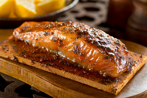 A single serving portion of delicious cedar smoked salmon.
