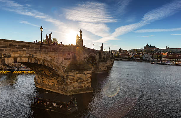 istock Charles bridge with sun and lens flare 611901820