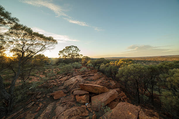 Beautiful sun setting down on the Australian outback. Kings Canyon in the far horizon.