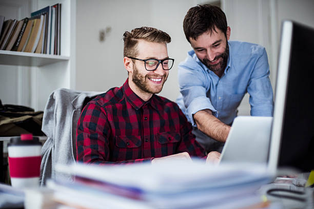 dois homens felizes no escritório. - small business manager designer partnership - fotografias e filmes do acervo