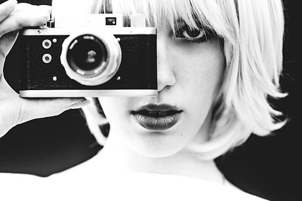 White Beauty capture with analog camera Beautiful girl filming with analog camera retro fashion stock pictures, royalty-free photos & images