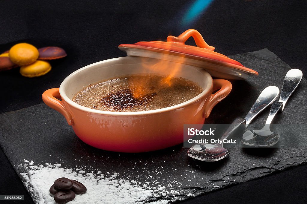 Flaming Creme Brulee Creme Brulee with flames, they way it is served. Creme Brulee Stock Photo