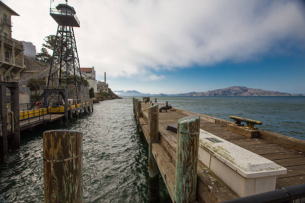 Alcatraz Island in San Francisco Bay includes a lighthouse, and prison, seen here in a moody view.