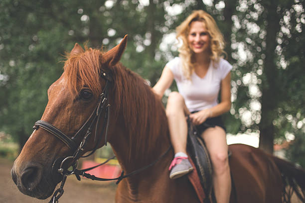 istock Pretty woman on a horse 611988620