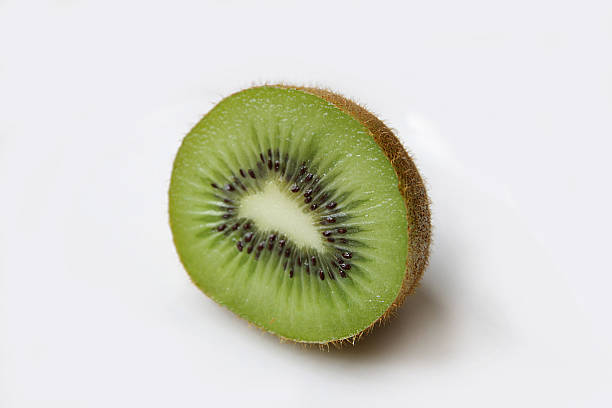 Half kiwi with white background stock photo