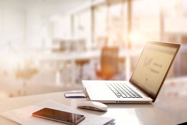 istock office desk with laptop smart phone and business office background. 611993552