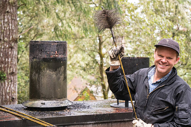 chimney sweep cleaning chimney - chimney sweeping imagens e fotografias de stock