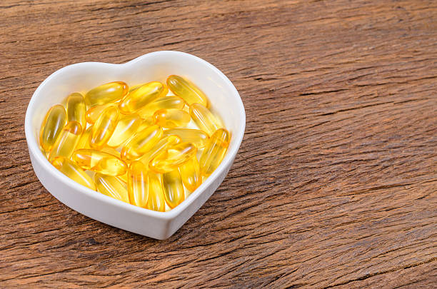 istock fish oil in heart shape bowl 611994488