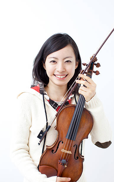 istock Woman holding a violin 611994976