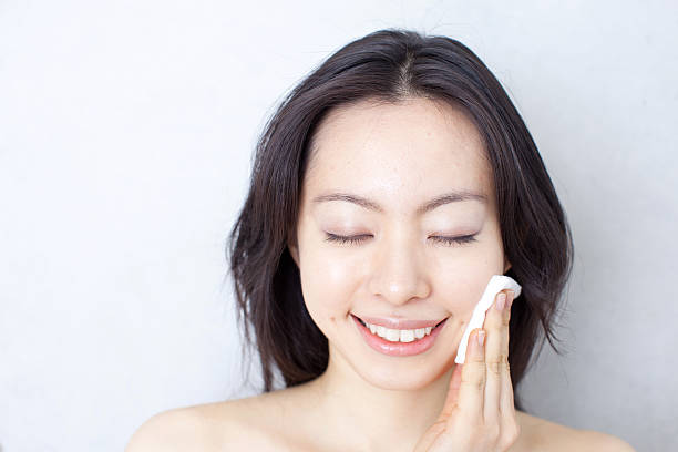 istock Woman wiping off makeup 611995680