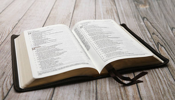 istock An Opened Bible on a White Distressed Wooden Table 611996180